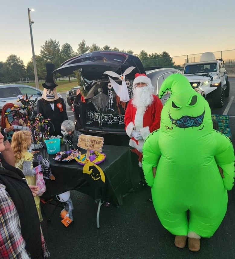 Trick or Treaters get candy from one of the decorated cars.